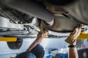 Mechanic,inspecting,vehicle's,catalytic,converter,during,scheduled,car,exhaust,system - meineke car care centers virginia - Meineke Car Care Centers Virginia