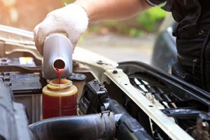 Male,hand,filling,car,power,steering,fluid - meineke car care centers virginia Meineke Car Care | Transmission Fluid | Richmond