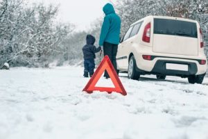 Woman,with,a,child,on,the,winter,road. ,emergency,sign - meineke car care centers virginia Engine Problems | Meineke Car Care | Yorktown, VA